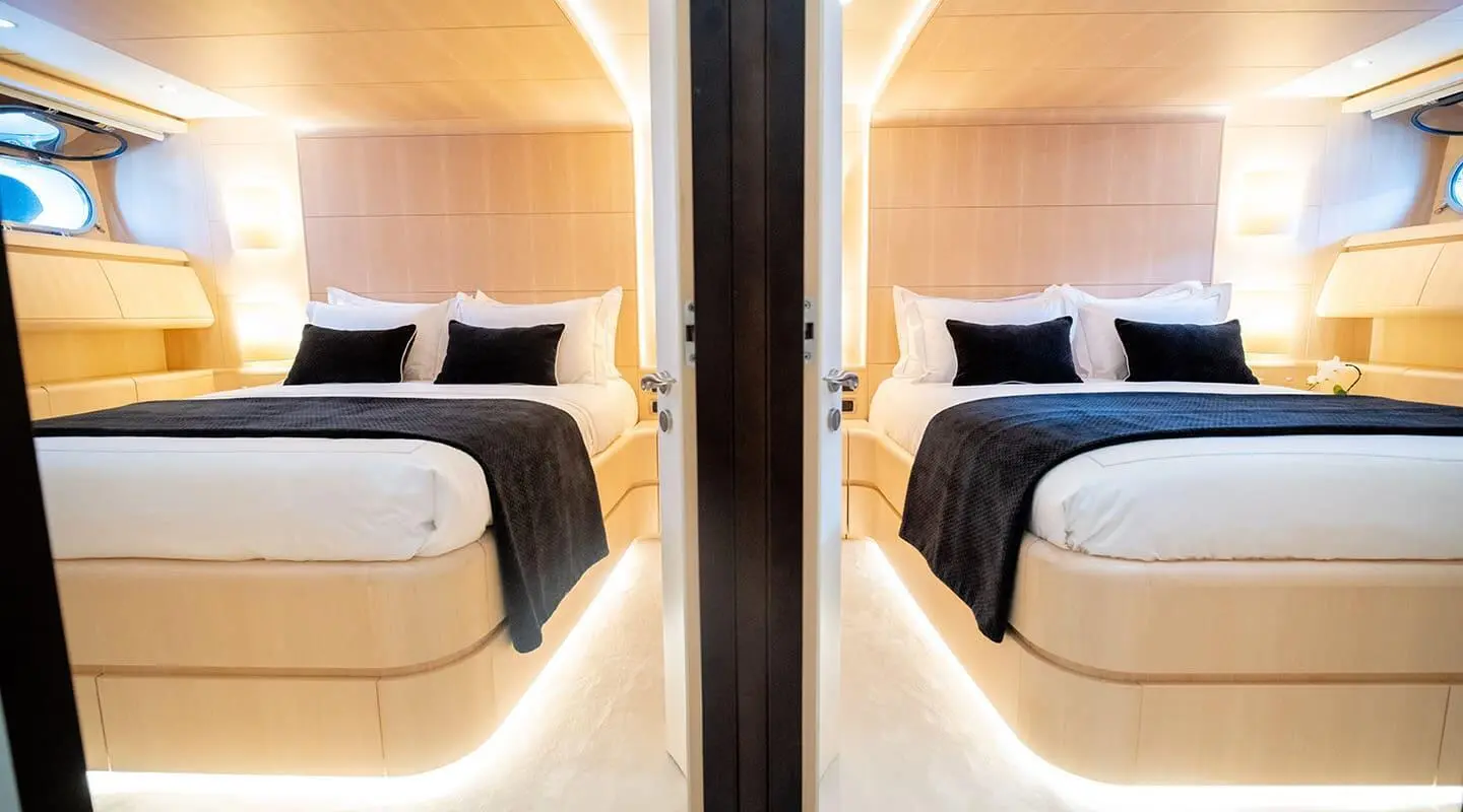 Pareaki II motor yacht hallway with two cabins and wood paneling