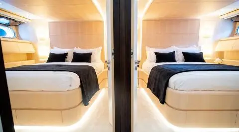 Pareaki II motor yacht hallway with two cabins and wood paneling