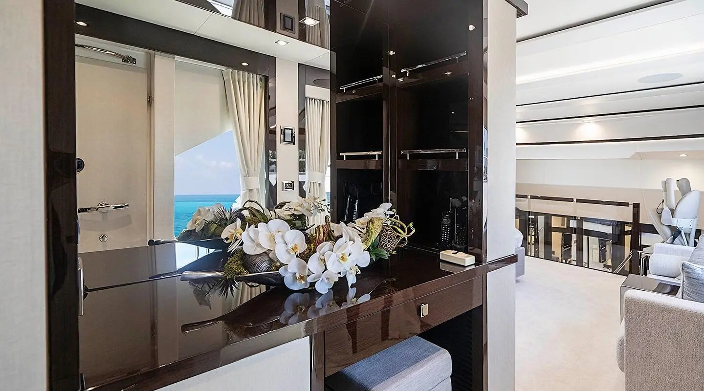 Luxurious Quantum yacht deck shown with polished wood, seating, and glass panels