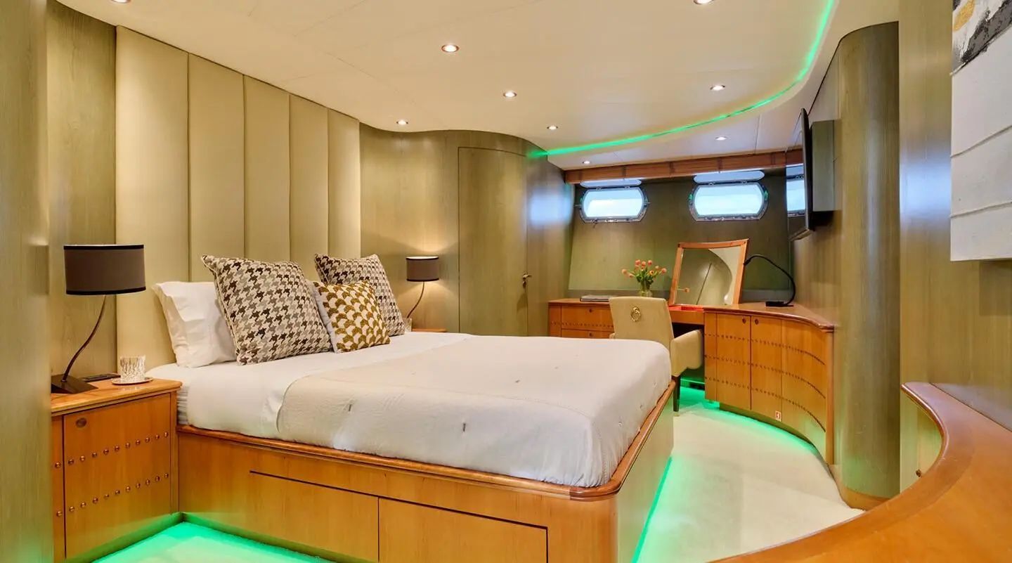 Mobius yacht interior cabin with large bed and wooden furniture