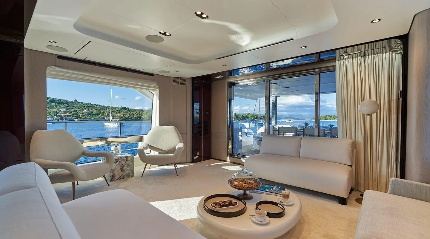 Interior of Aluminia Too yacht salon at sunset with seating and round coffee table