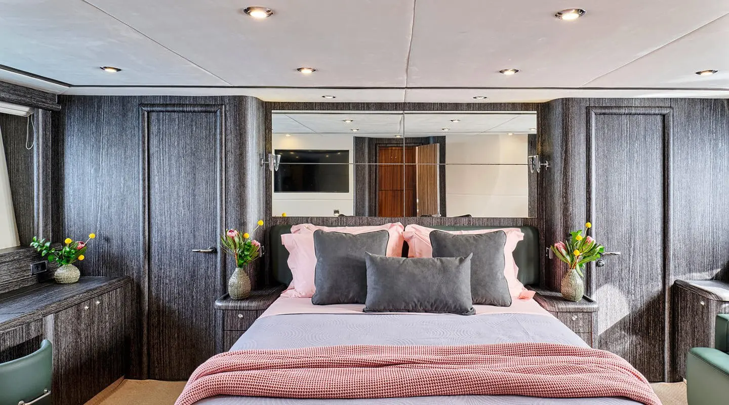 Luxurious yacht M Five master cabin with stylish bedding and soft lighting