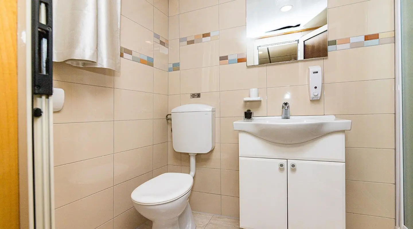 Modern bathroom with toilet and sink in a small space