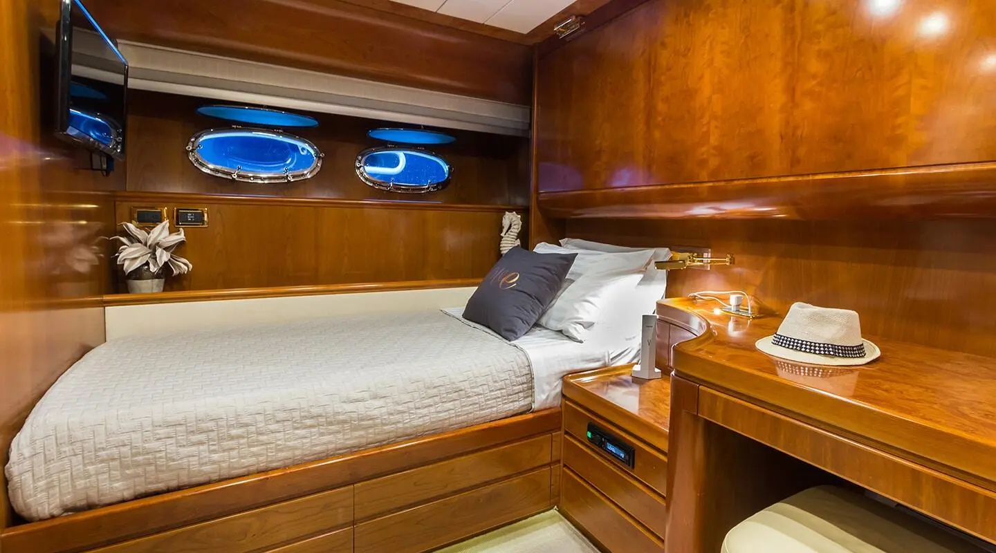 Interior cabin of Amoraki motor yacht with double berth and wood paneling