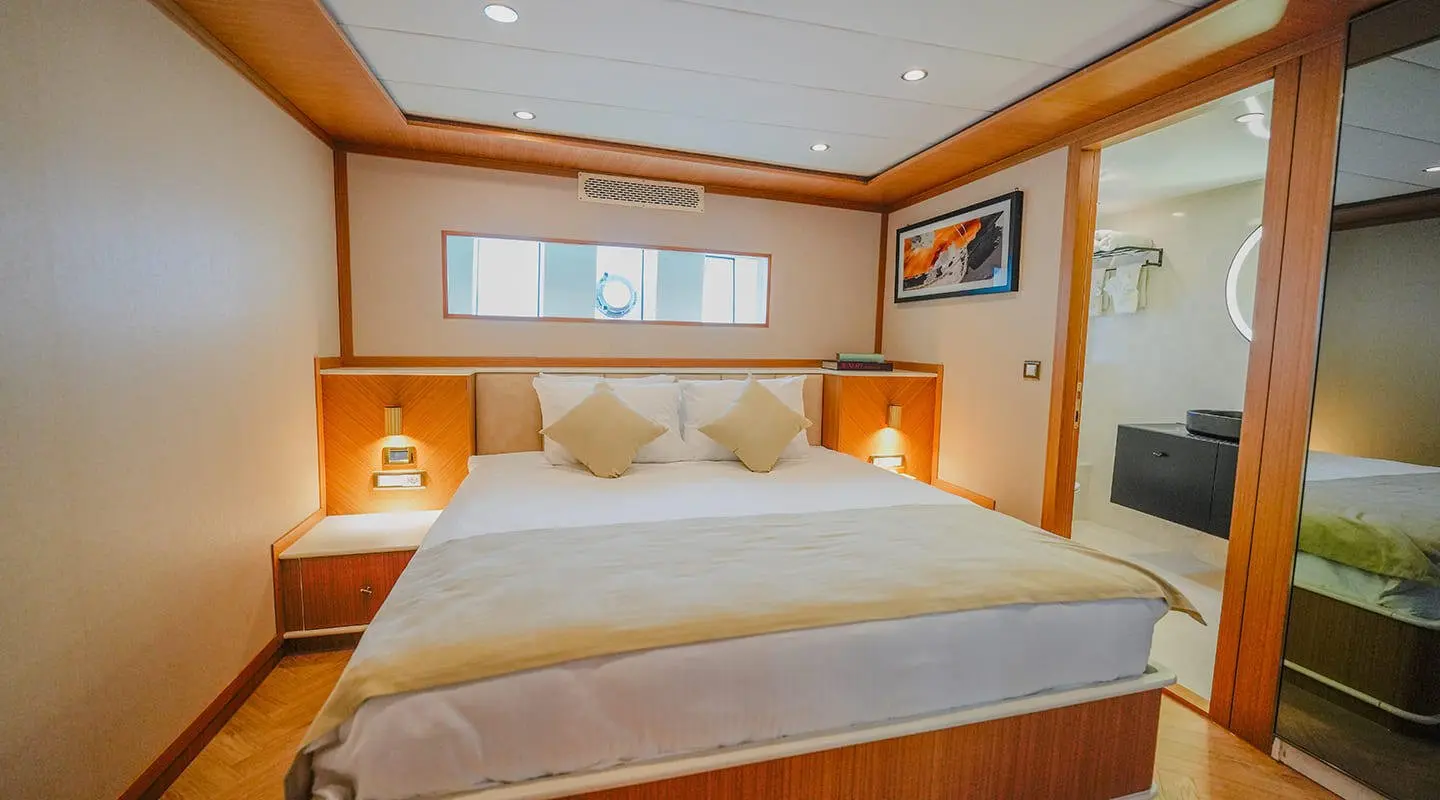 King of the Sea luxury yacht bedroom with wooden walls and a large bed