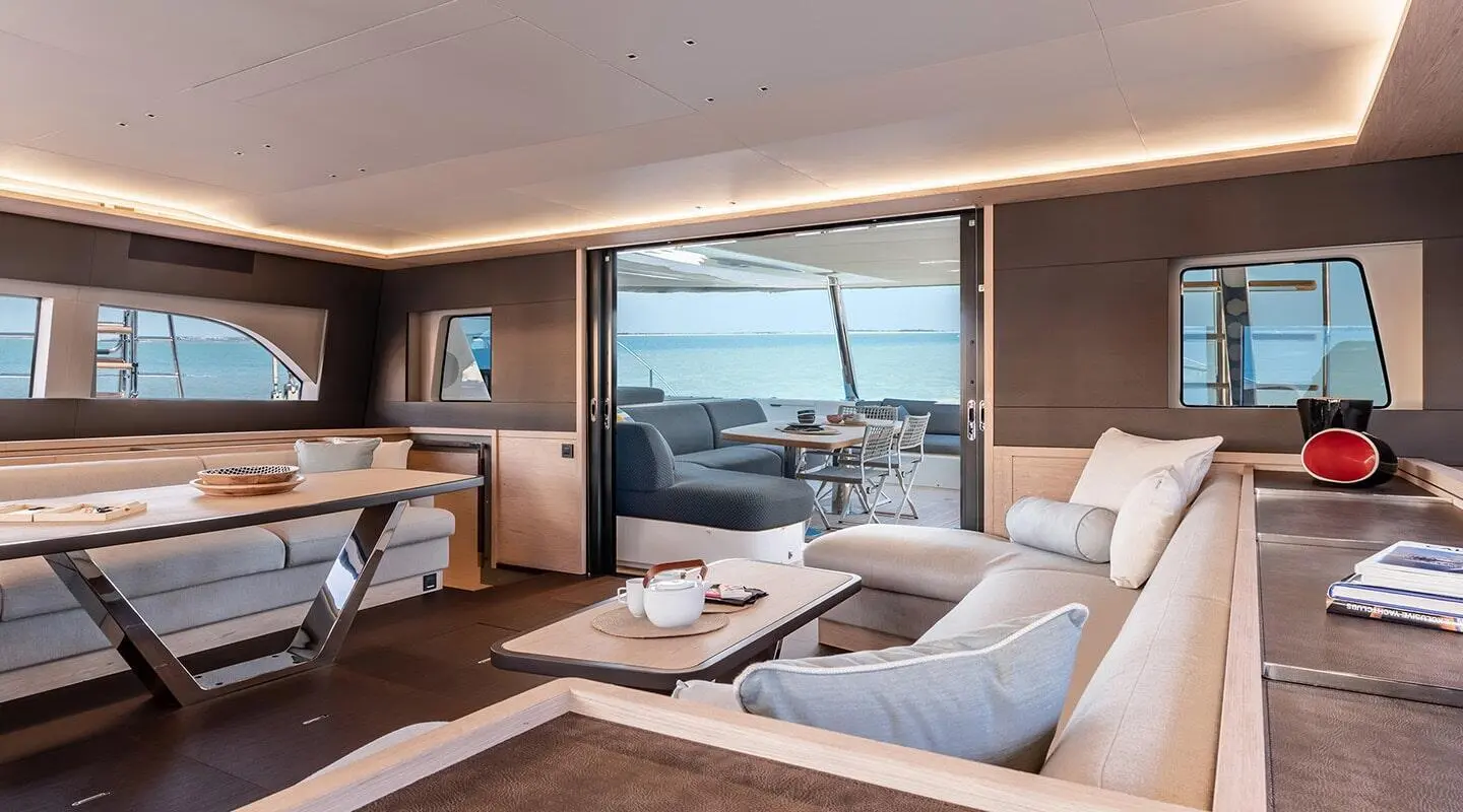 Interior of Daiquiri yacht saloon with white seating and large window view
