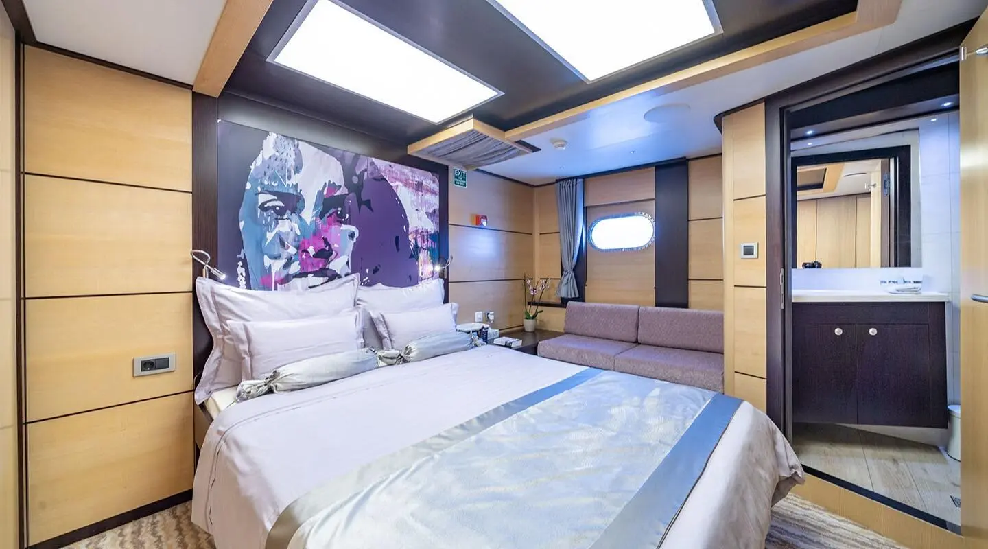 Navilux yacht bed deck view with two large beds and wooden cabinetry