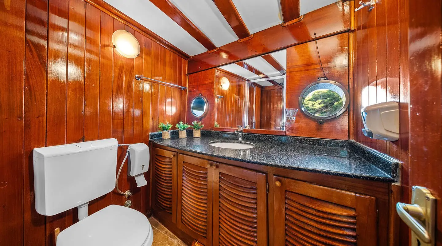 Elegant yacht interior with polished wood cabinets and a curved window