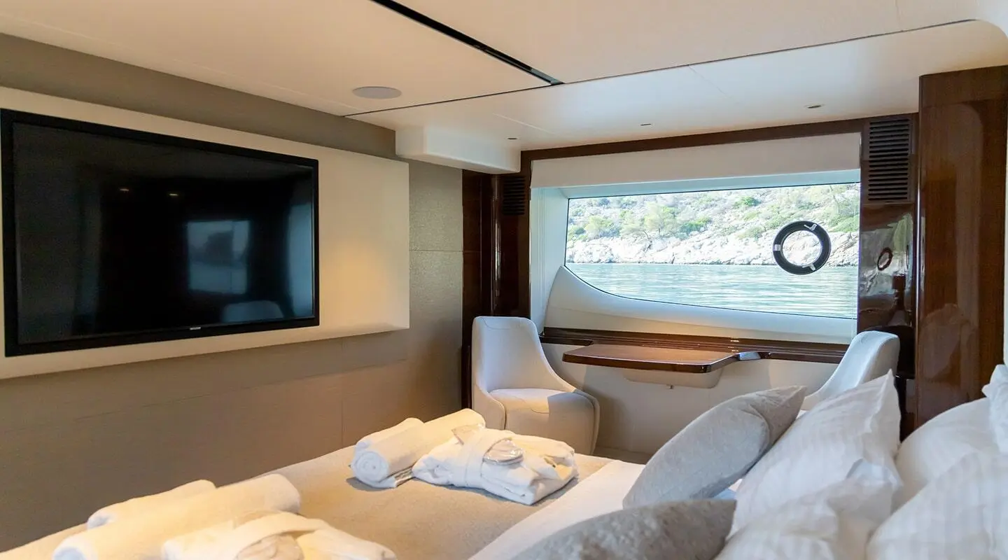 Vista yacht deck lounge with sofa, cushions, and large window view