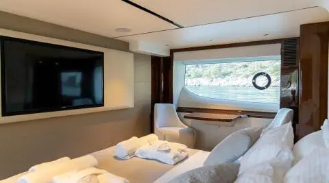 Vista yacht deck lounge with sofa, cushions, and large window view