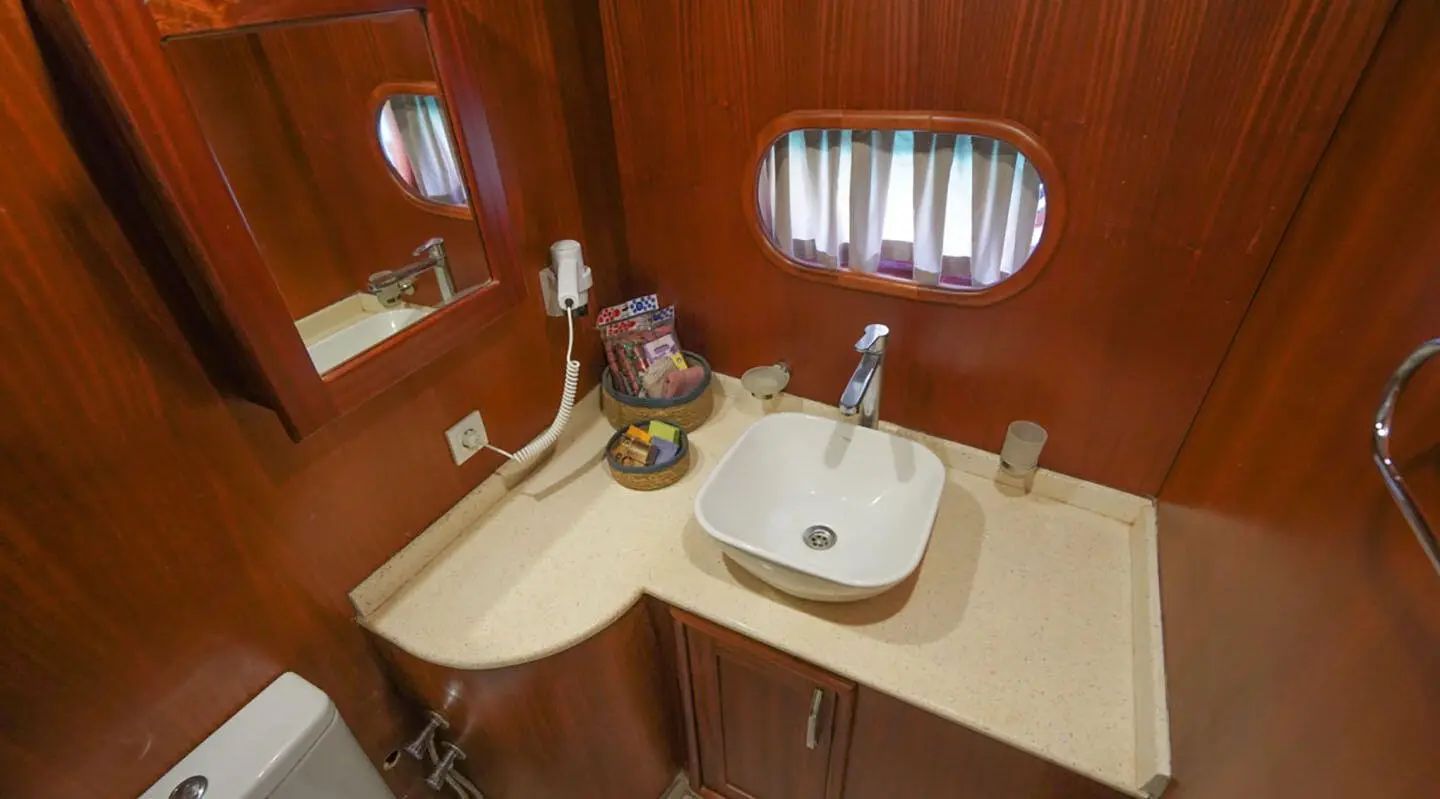 Interior of Prenses Esila yacht with wood paneling, sink, and small window