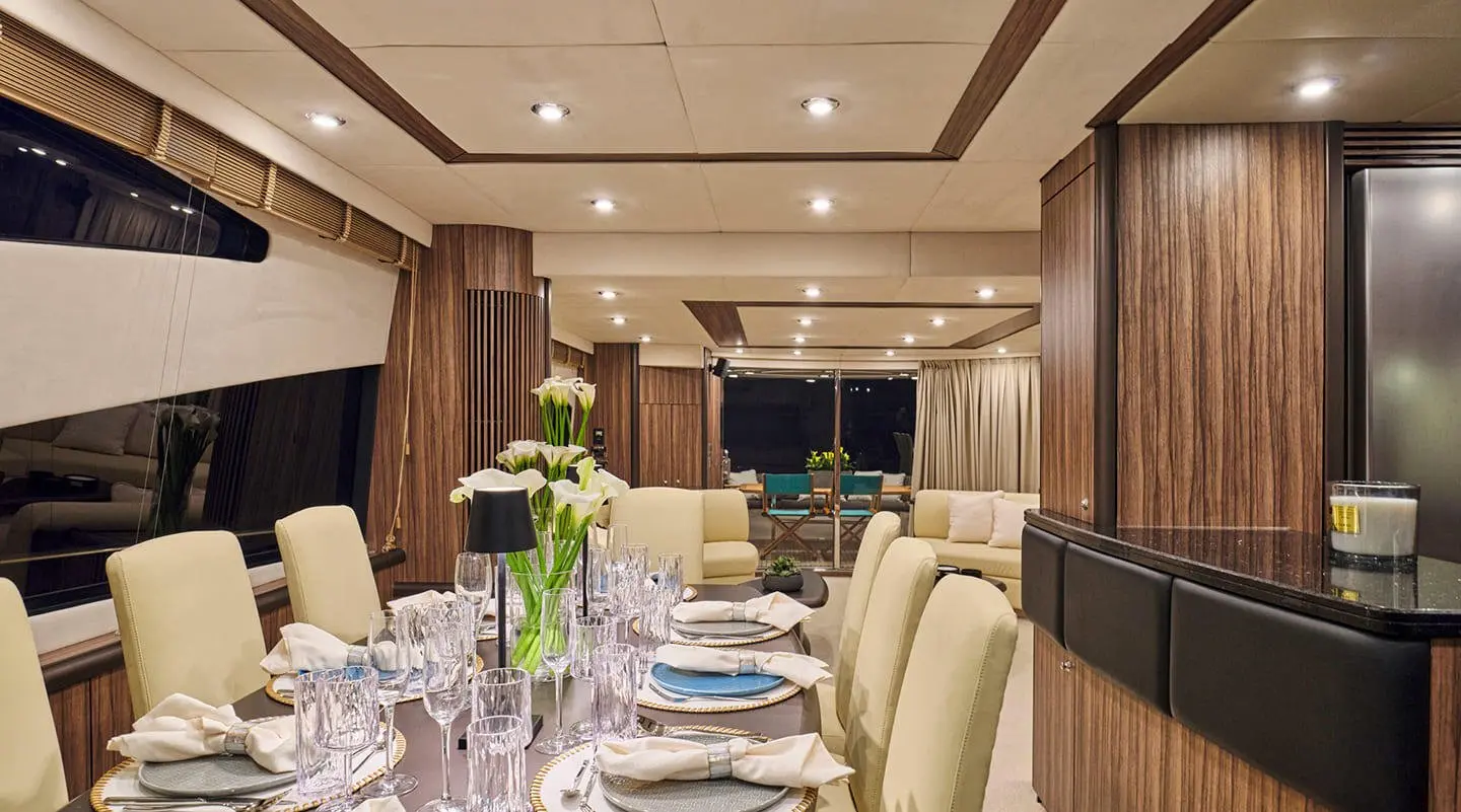 Interior dining area aboard M Five yacht with table setting and chairs