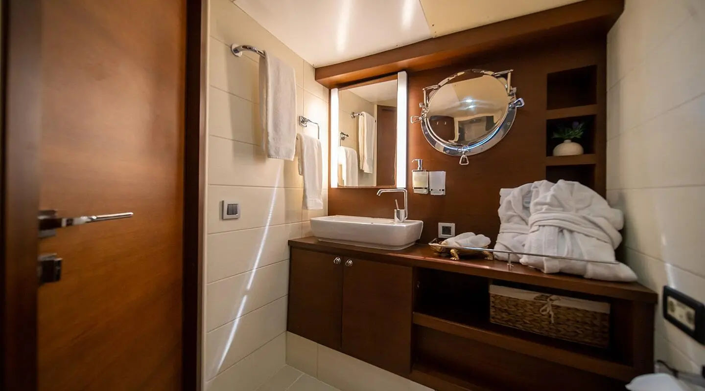 Double Eagle yacht charter, interior cabin with wooden desk and mirror, dim lighting