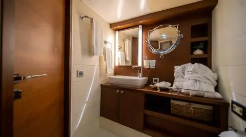 Double Eagle yacht charter, interior cabin with wooden desk and mirror, dim lighting