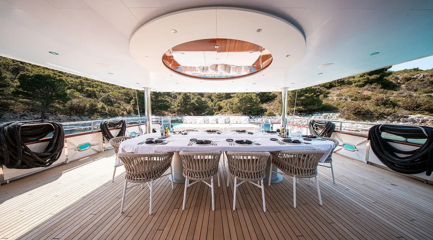 Nocturno luxury motor yacht dining area with round ceiling light and seating