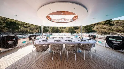 Nocturno luxury motor yacht dining area with round ceiling light and seating