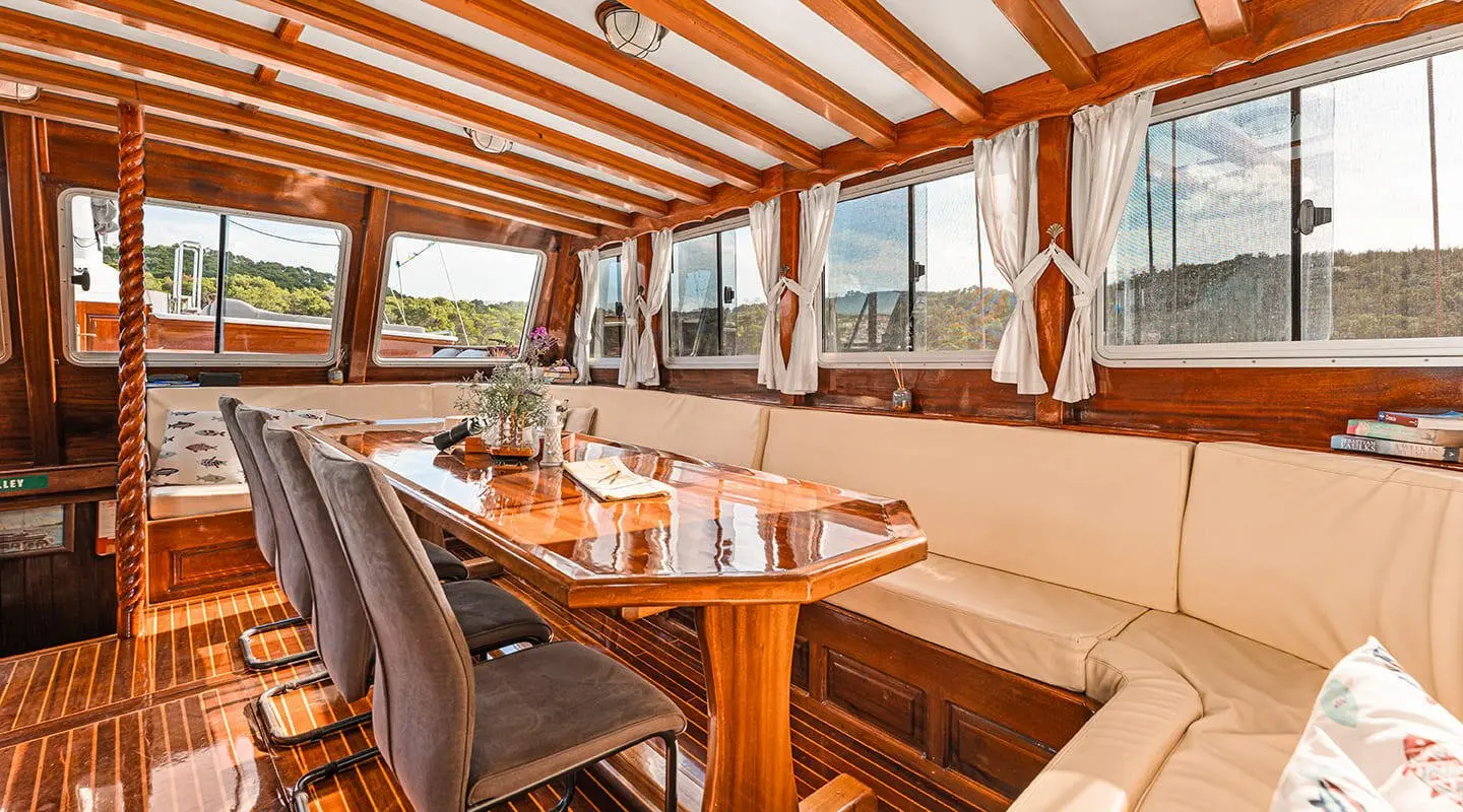 Luxurious wooden deck of a Croatia yacht at sunset with seating and umbrella setup