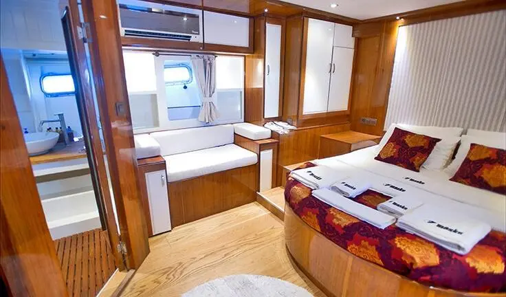 Maske 2 master cabin with king bed and ensuite, wood paneling and seating area
