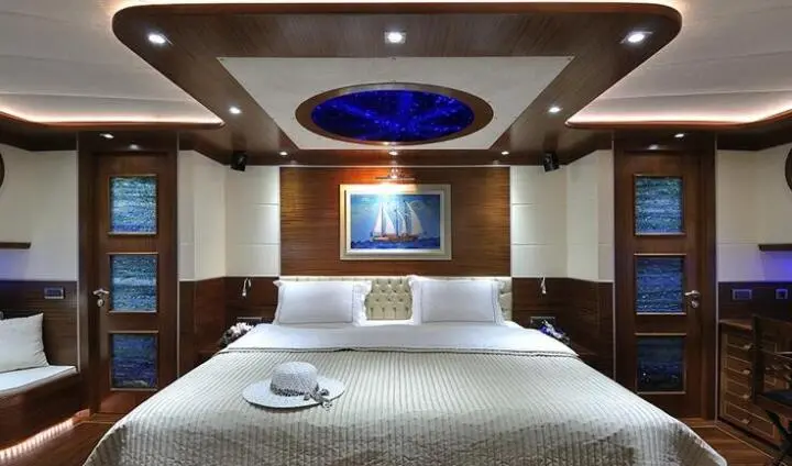 Dolce Mare master cabin interior with bed, overhead lighting, and framed artwork