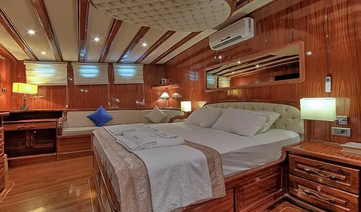Master cabin on Lycian Queen yacht featuring a king bed and ensuite hints