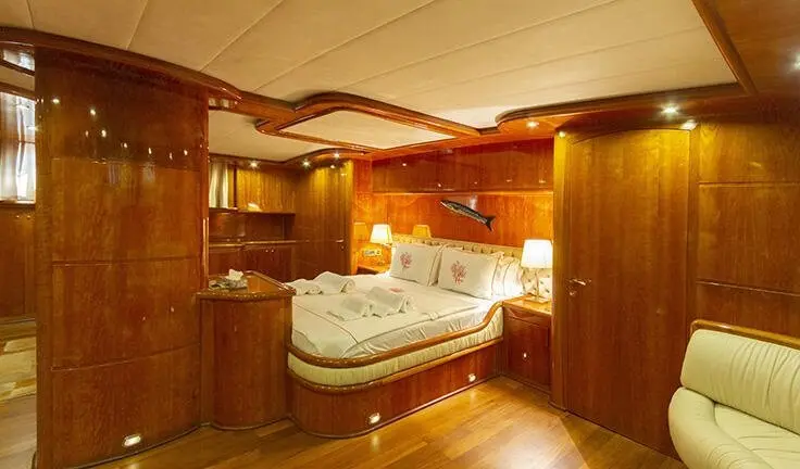 Silver Moon cabin interior with polished wood panels, plush bed, and ambient lighting