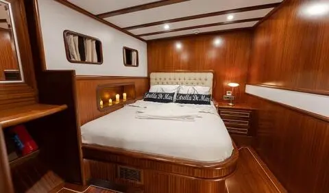 Estrella De Mar master cabin with king bed and wooden paneling
