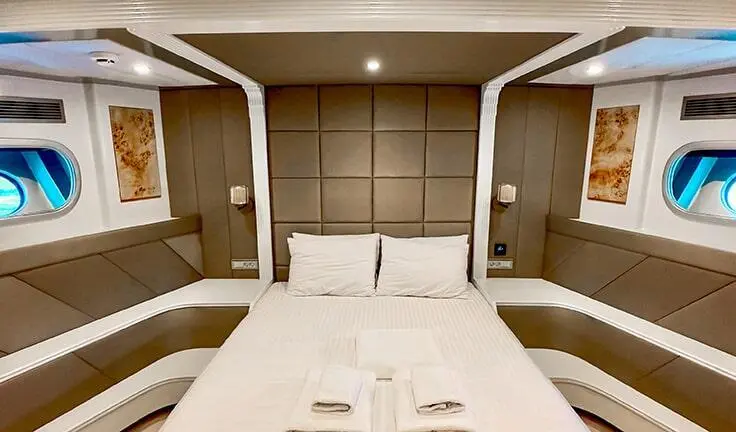 Angelo III yacht cabin with a double bed and private ensuite doors
