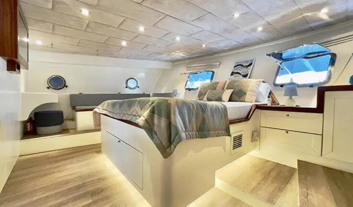 Derya Deniz master cabin with king bed, ensuite, wood floors, soft lighting