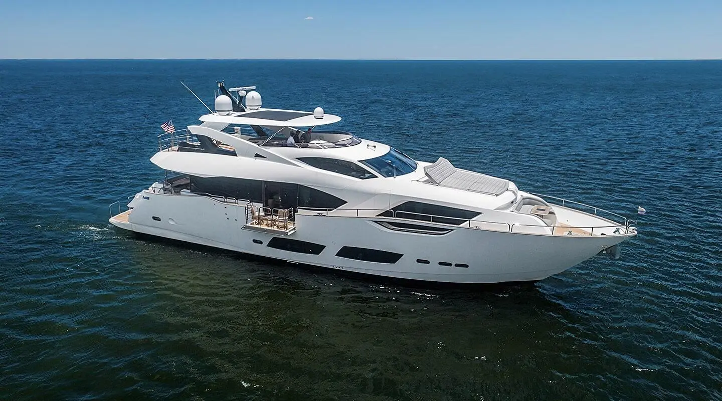 Luxury motor yacht Quantum anchored on calm blue sea with clear sky