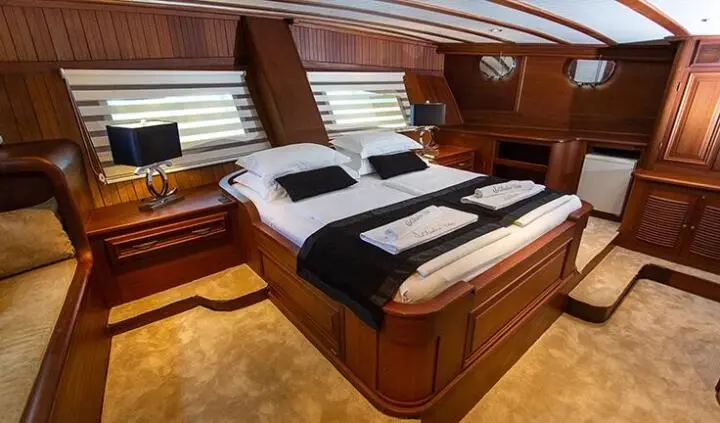 Dolce Vita master cabin with king bed, wood tones, ensuite visible