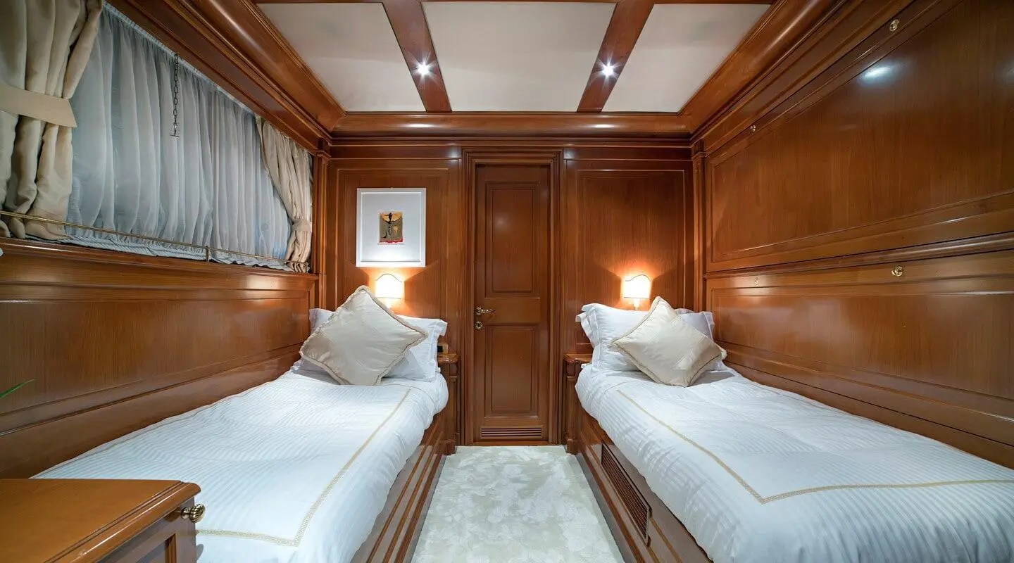 Aquila motoryacht twin cabin interior with two single beds and wooden walls