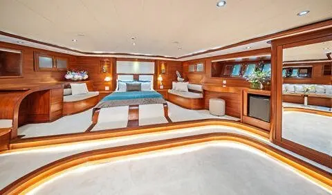 Interior of gulet Alessandro I master cabin lounge with wooden cabinetry and seating.