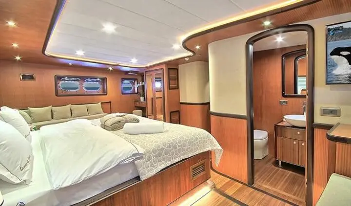 Queen Of Salmakis master cabin with king bed and ensuite bathroom visible