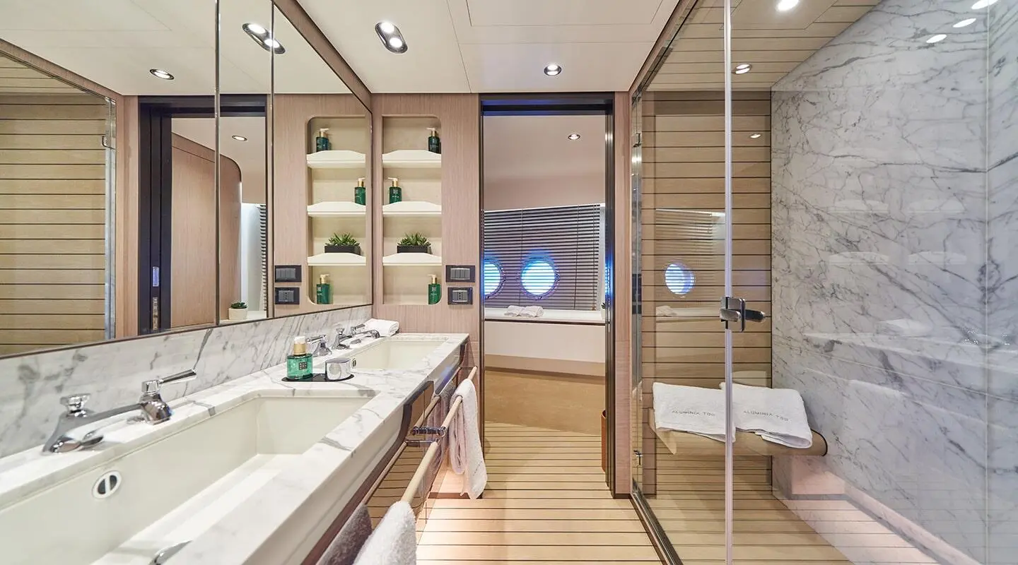 Aluminia Too luxury yacht bathroom interior with marble countertops and teak accents
