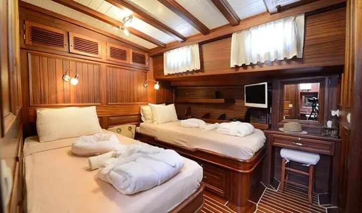 Zephyria II twin cabin interior with wooden panels and two beds