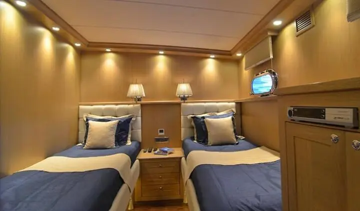 Twin cabin interior on Blue Heaven yacht with two neatly made beds