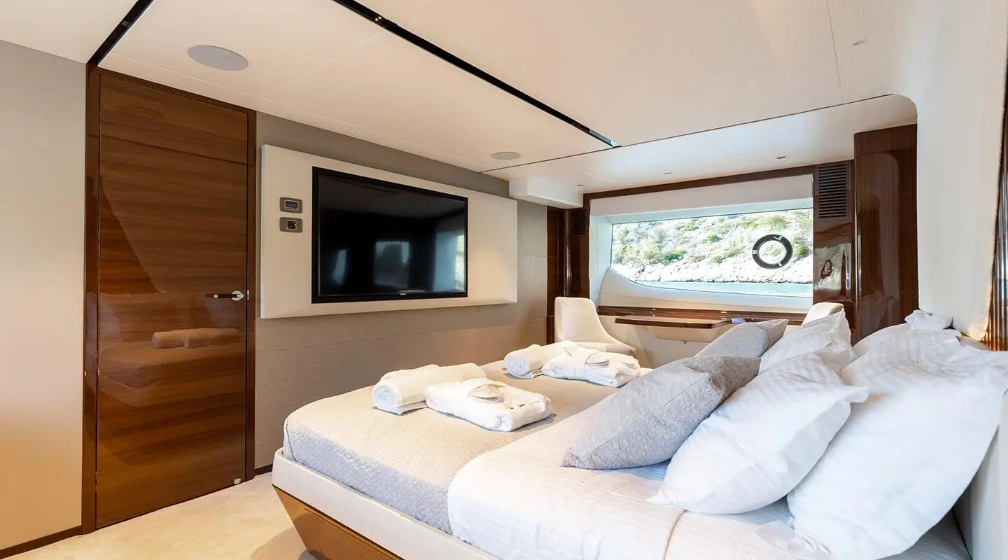 Silhouetted luxury yacht Vista at sea with calm water and sunset glow