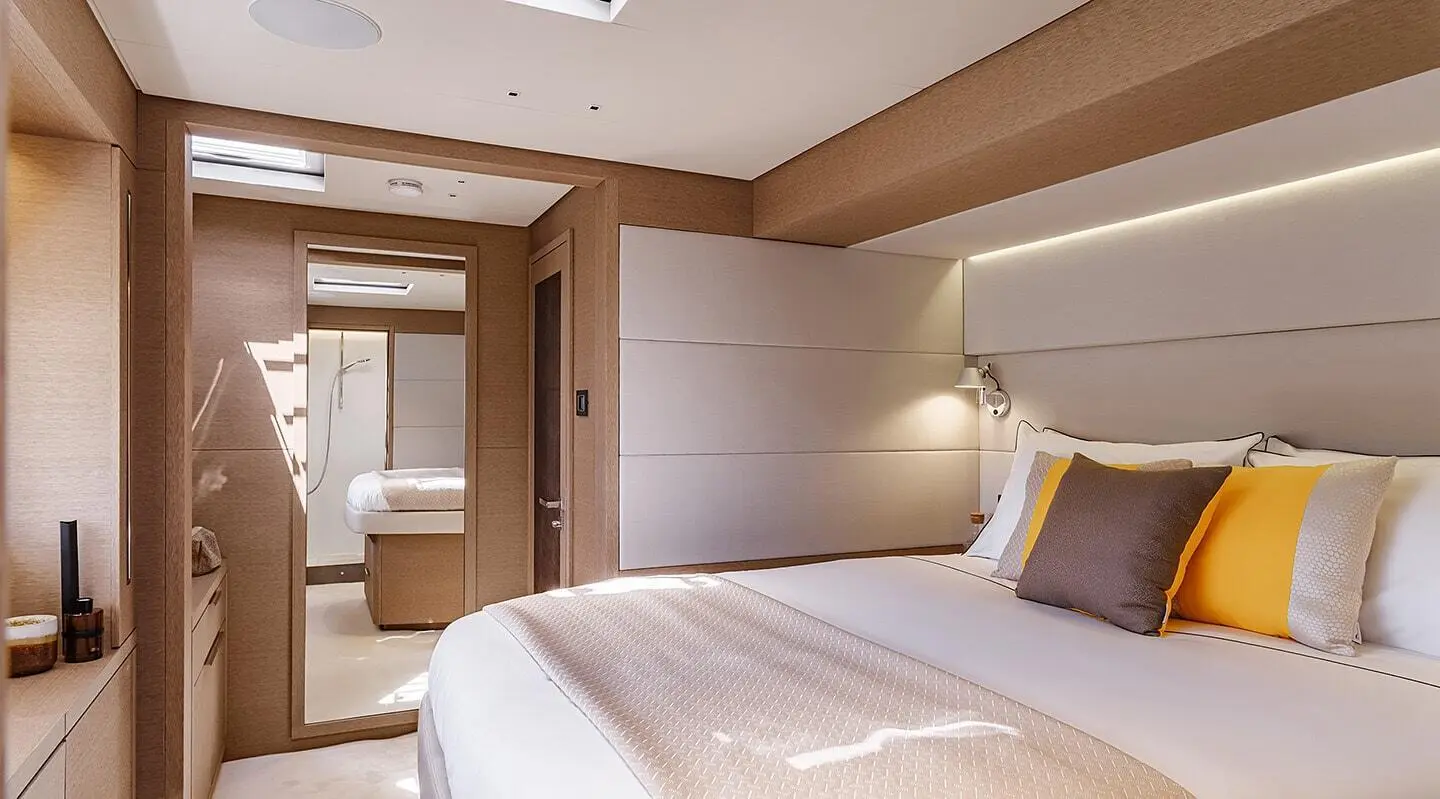 Luxurious yacht Daiquiri interior: bright bedroom with plush bed and wooden accents