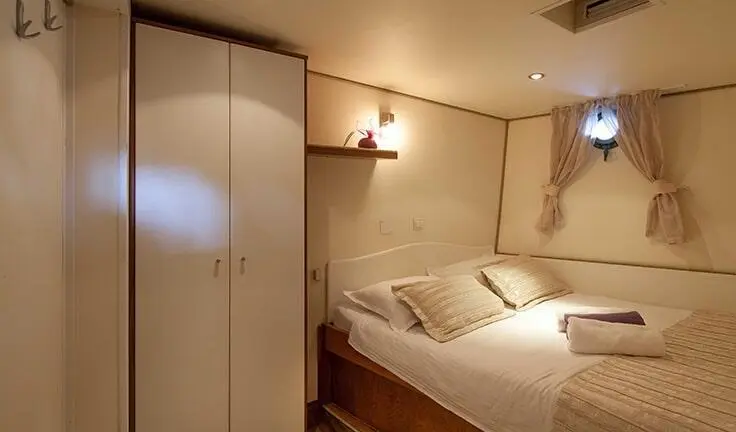 Romanca yacht cabin with double bed and queen-size layout, warm lighting