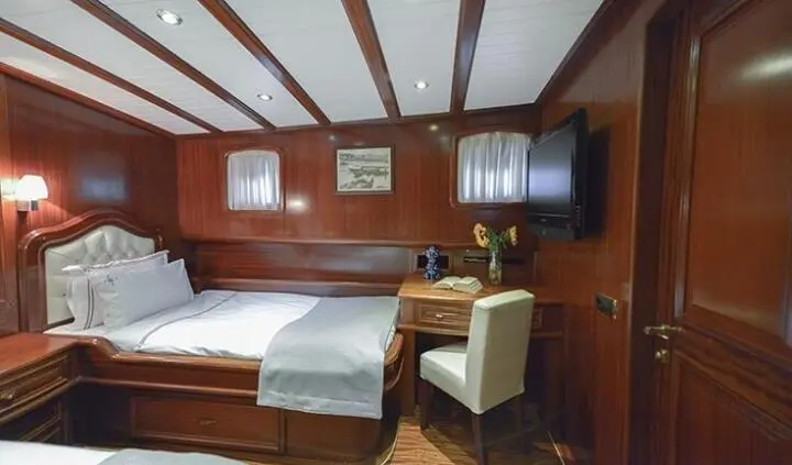Twin cabin on Lady Christa yacht with wooden interior and two beds