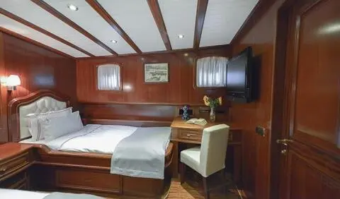 Twin cabin on Lady Christa yacht with wooden interior and two beds