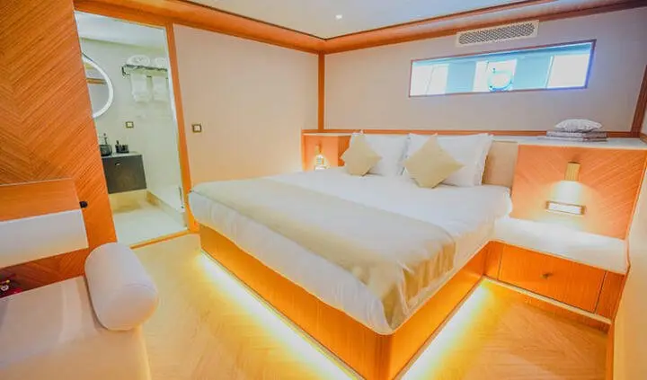 King Of The Sea Master Cabin interior with queen bed and warm lighting