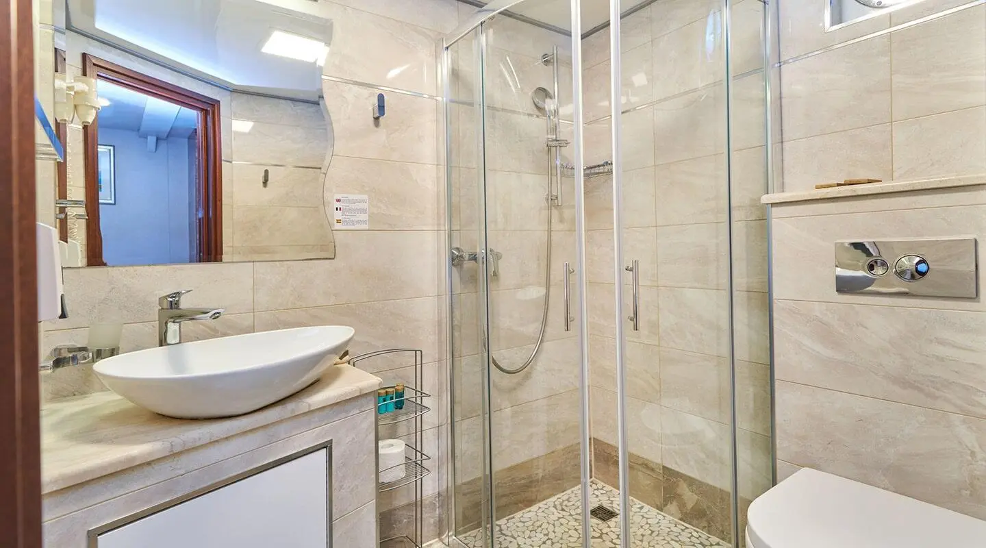 Casablanca luxury yacht bathroom with glass shower enclosure and beige tiled walls