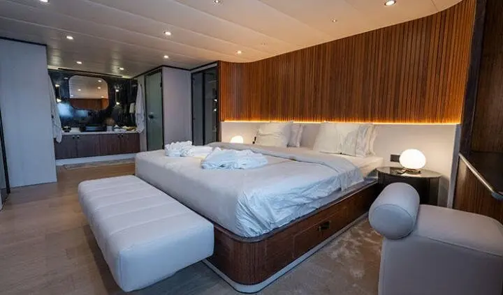Master cabin with king bed, ensuite, wood paneling, soft lighting