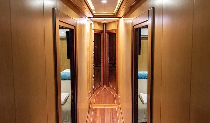 Kayhan 3 master cabin with king bed and ensuite bathroom, hallway.
