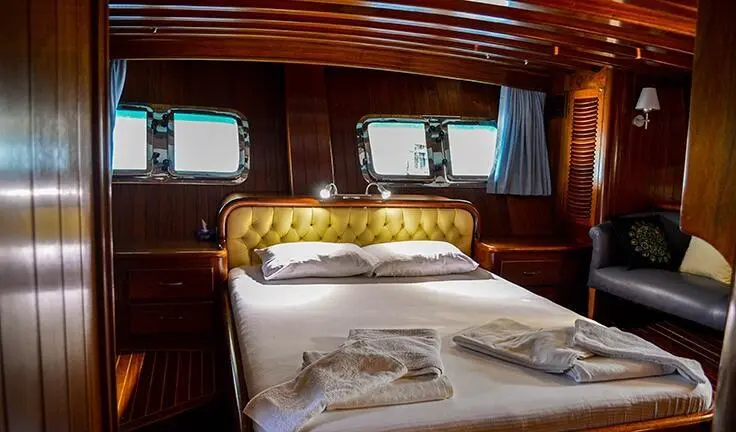 Two single beds with white bedding and wooden cabin interior