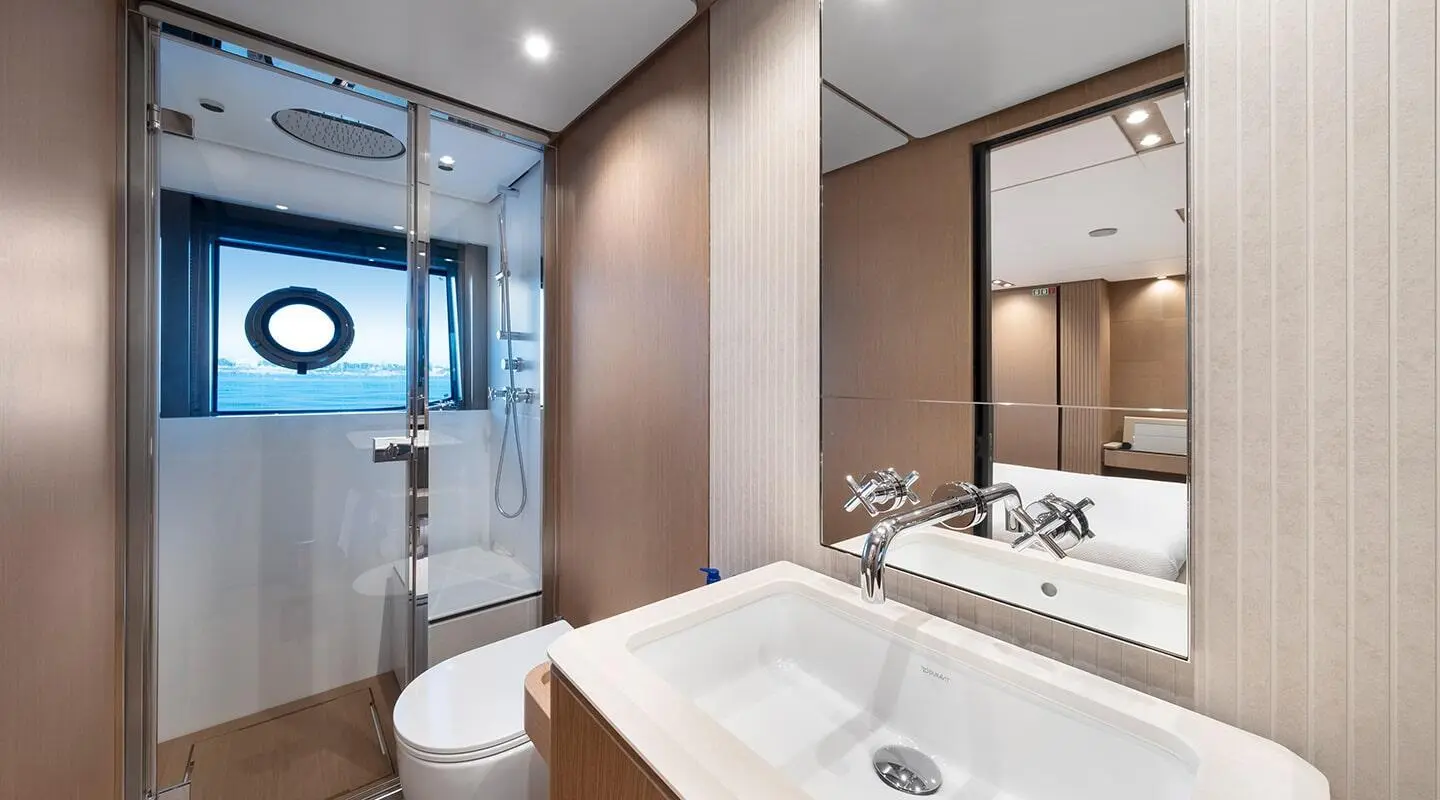 Spica luxury yacht bathroom interior with sink, mirror, and beige decor