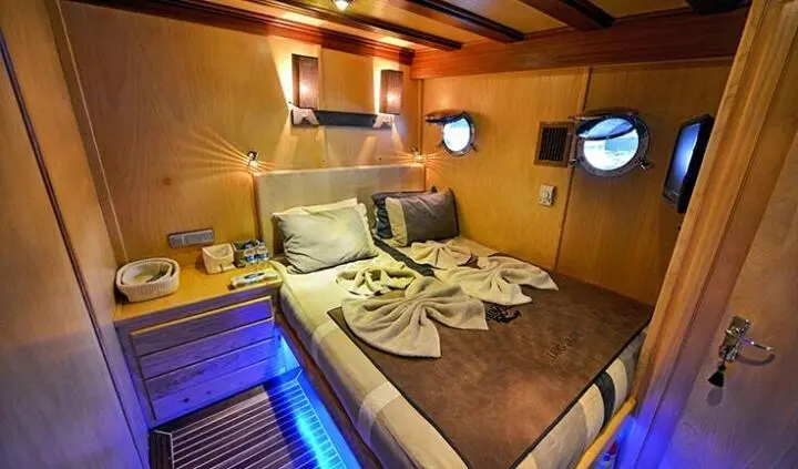 Cozy master cabin with king bed, ensuite, wood paneling, and soft lighting