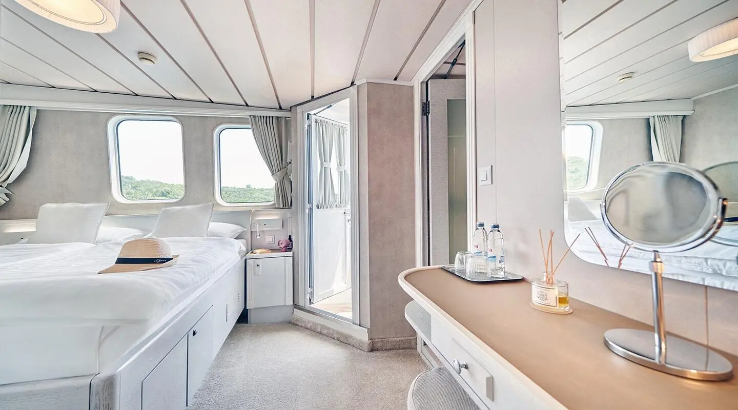 La Perla luxury yacht interior: aft cabin with bed, windows, and vanity