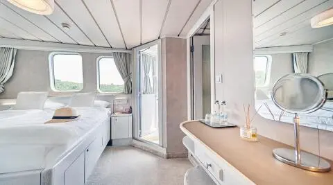 La Perla luxury yacht interior: aft cabin with bed, windows, and vanity